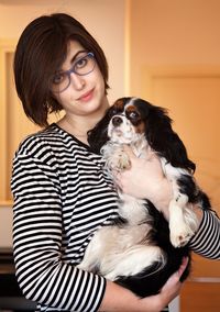 Portrait of a smiling young woman with dog