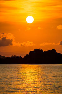 Scenic view of sea against orange sky