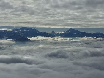 Scenic view of cloudscape over mountains against sky