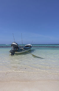 Ship moored on sea against sky