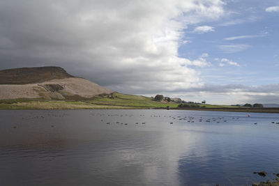 View of river against cloudy sky