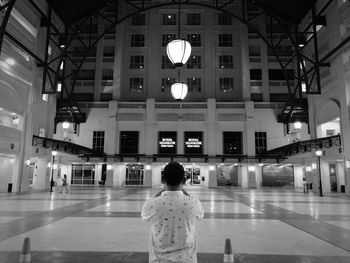 Rear view of man standing in corridor