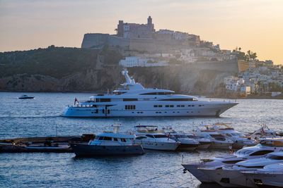 Boats in sea against buildings