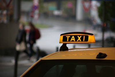 Taxi sign on car roof with bokeh background at airport