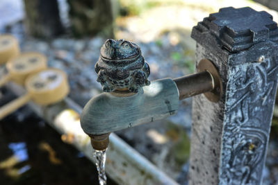 Close-up of water fountain with bamboo ladles