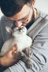 Midsection of man with cat
