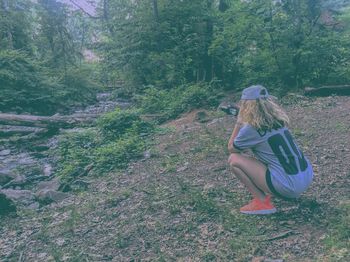 Woman standing in forest