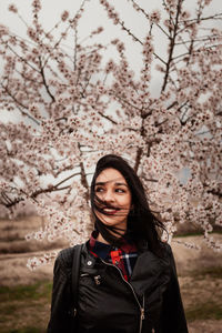Portrait of a smiling young woman standing outdoors