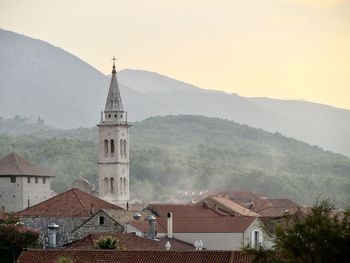 High angle view of a church in jelsa, croatia and mountains against sky