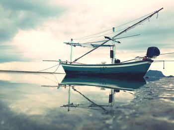Sailboats in sea against sky
