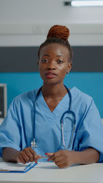 Portrait of smiling female doctor holding stethoscope