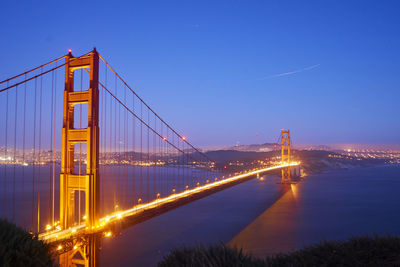 Suspension bridge in city at night