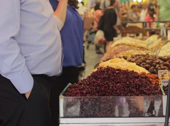 Midsection of people  standing in market stall