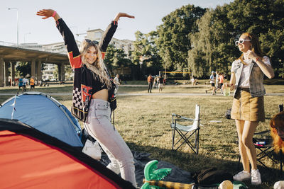 Female friends enjoying while camping during music event