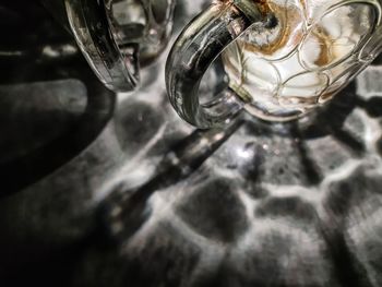 High angle view of drinking glass in jar on table
