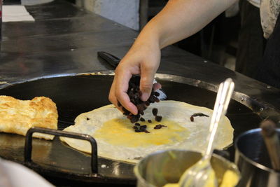 Close-up of person preparing food in kitchen