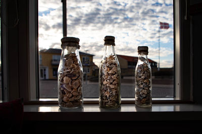 Close-up of glass jar on window sill