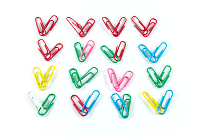 Close-up of colorful paper clips arranged on white background