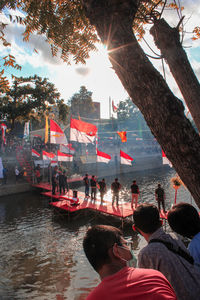 People in boat against trees