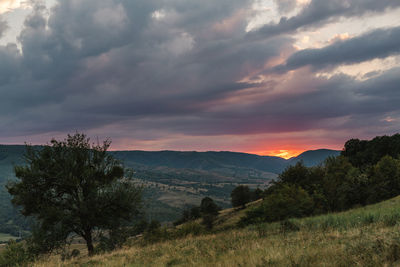 Scenic view of landscape against dramatic sky