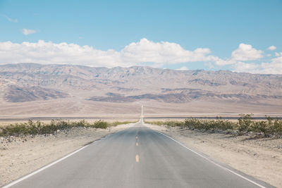 Road amidst landscape against sky