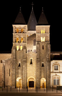 Illuminated building against sky at night