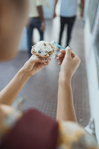 Midsection of woman holding ice cream