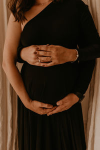 Midsection of woman standing at home