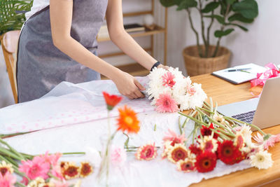 Midsection of woman holding bouquet