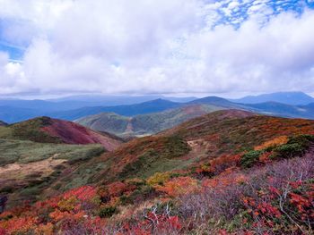 Scenic view of mountains against cloudy sky