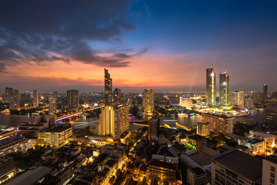 High angle view of illuminated city buildings against sky