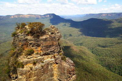 Scenic view of land and mountains against sky