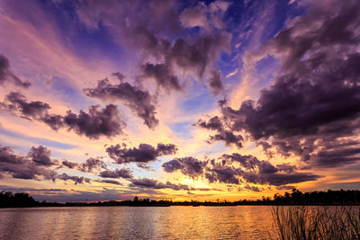 Scenic view of lake against romantic sky at sunset