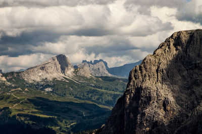 Scenic view of dolomites against cloudy sky