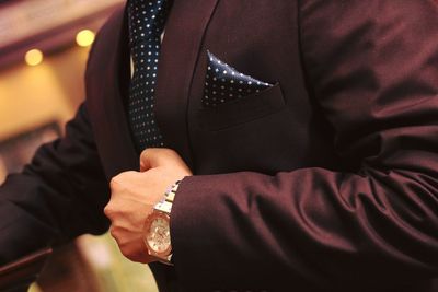 Midsection of man wearing suit