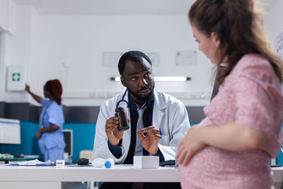 Side view of doctor examining patient at clinic