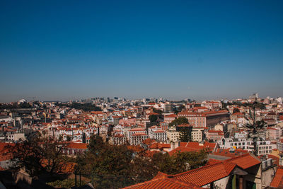 High angle view of cityscape against clear blue sky