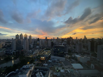 High angle view of modern buildings against sky during sunset