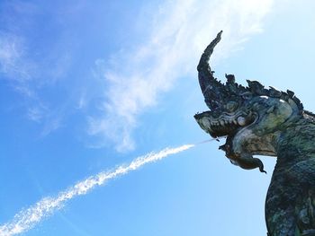 Low angle view of giraffe against blue sky