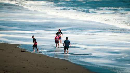 People on beach against sea