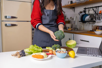 Midsection of woman preparing food on table