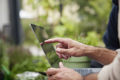 Midsection of man using mobile phone