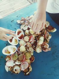 High angle view of hand holding ice cream on table