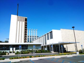 Low angle view of office building against blue sky