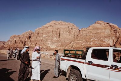 Panoramic view of people on mountain road against clear sky