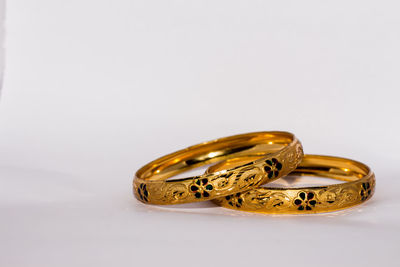 Close-up of wedding rings on metal against white background