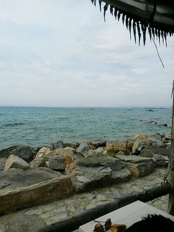 VIEW OF CALM BEACH AGAINST BLUE SKY