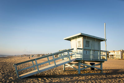 Built structure on beach against clear sky