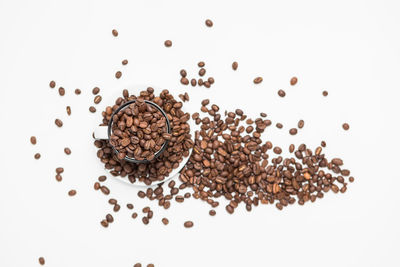 High angle view of coffee beans against white background