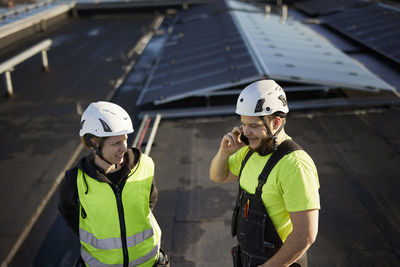 Workers standing on roof